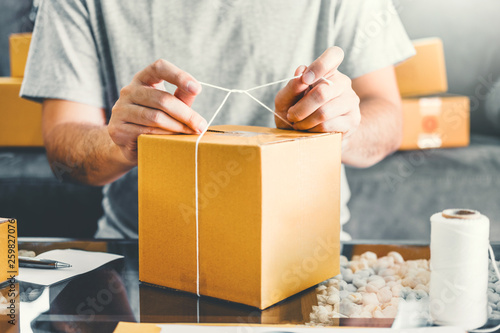 SME freelance man working with packaging startup entrepreneur small business owner at home,Online business seller packaging and delivery concept