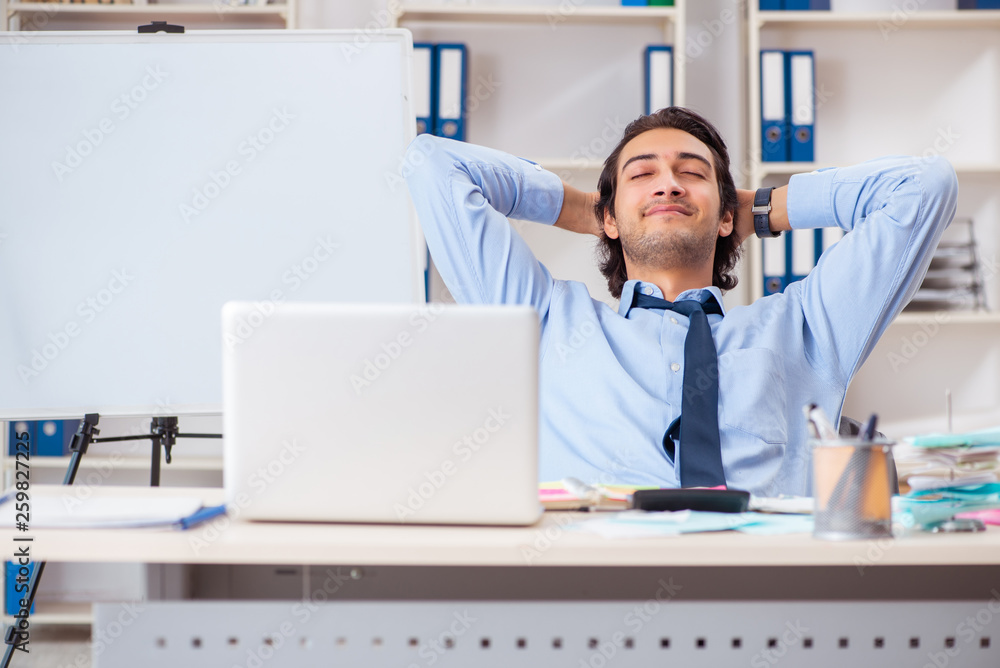 Young handsome businessman in budget planning concept Young handsome businessman in budget planning concept