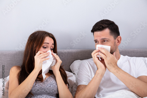 Young Couple Blowing Their Nose