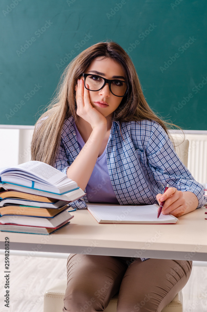 Female student in front of chalkboard Female student in front of chalkboard