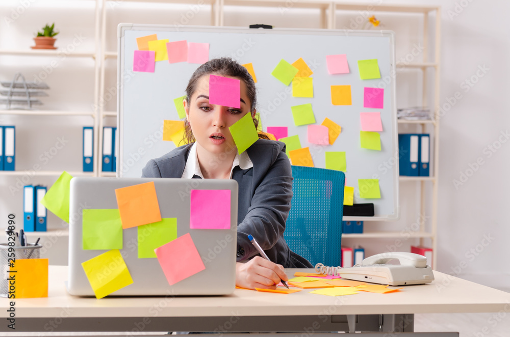 Young female employee in conflicting priorities concept Young female employee in conflicting priorities concept