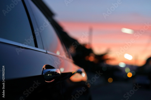 luxury vehicle black car with blur twilight dramatic sky, image selective focus on door handle photo