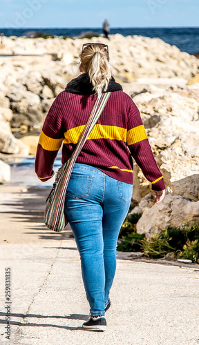 Woman with big booty in jeans walking down the street Stock Photo | Adobe  Stock