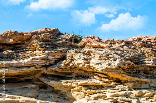 Sandstone sea rock against the sky