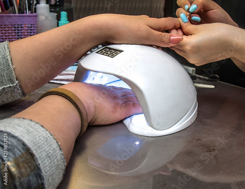 Drying nail polish in a beauty salon photo