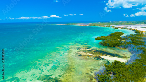 Fototapeta Naklejka Na Ścianę i Meble -  Aerial view of Puerto Rico. Faro Los Morrillos de Cabo Rojo. Playa Sucia beach and Salt lakes in Punta Jaguey. 