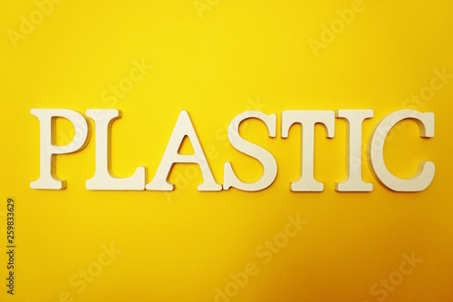 Plastic alphabet letters on yellow background