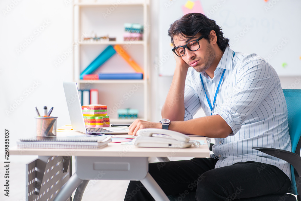 Young handsome male designer working in the office Young handsome male designer working in the office