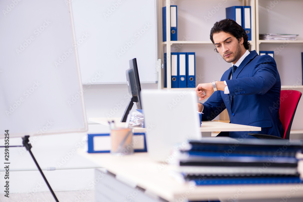 Young handsome businessman working in the office Young handsome businessman working in the office