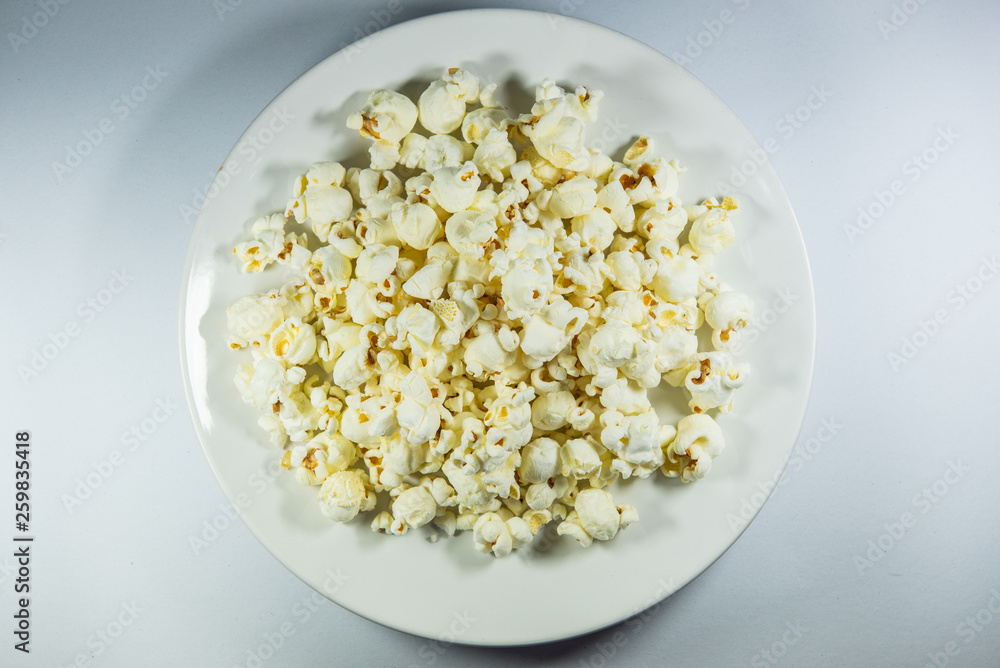 Popcorn in a plate on white background Popcorn in a plate on white background