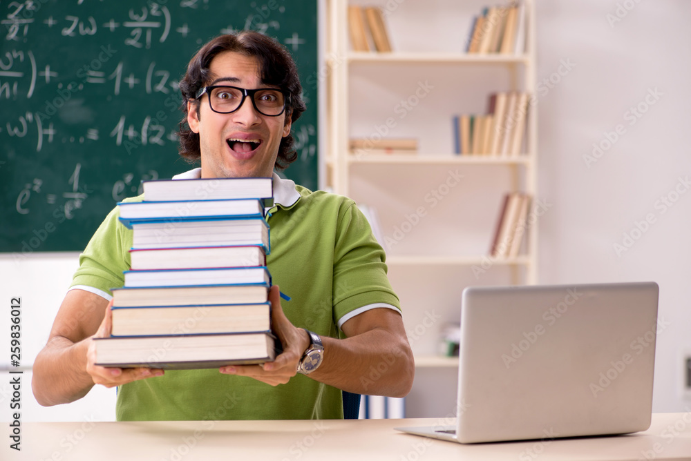 Handsome student in front of chalkboard with formulas Handsome student in front of chalkboard with formulas
