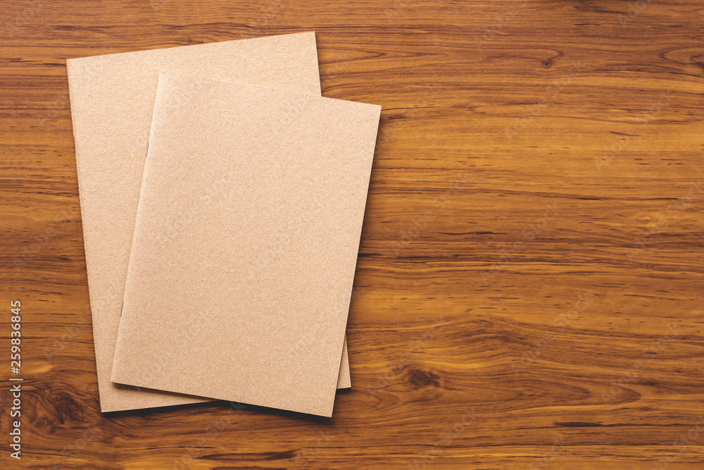 Notebook isolated on wooden table background Notebook isolated on wooden table background
