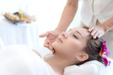 beautiful and healthy young woman relaxing with face massage  at beauty spa salon
