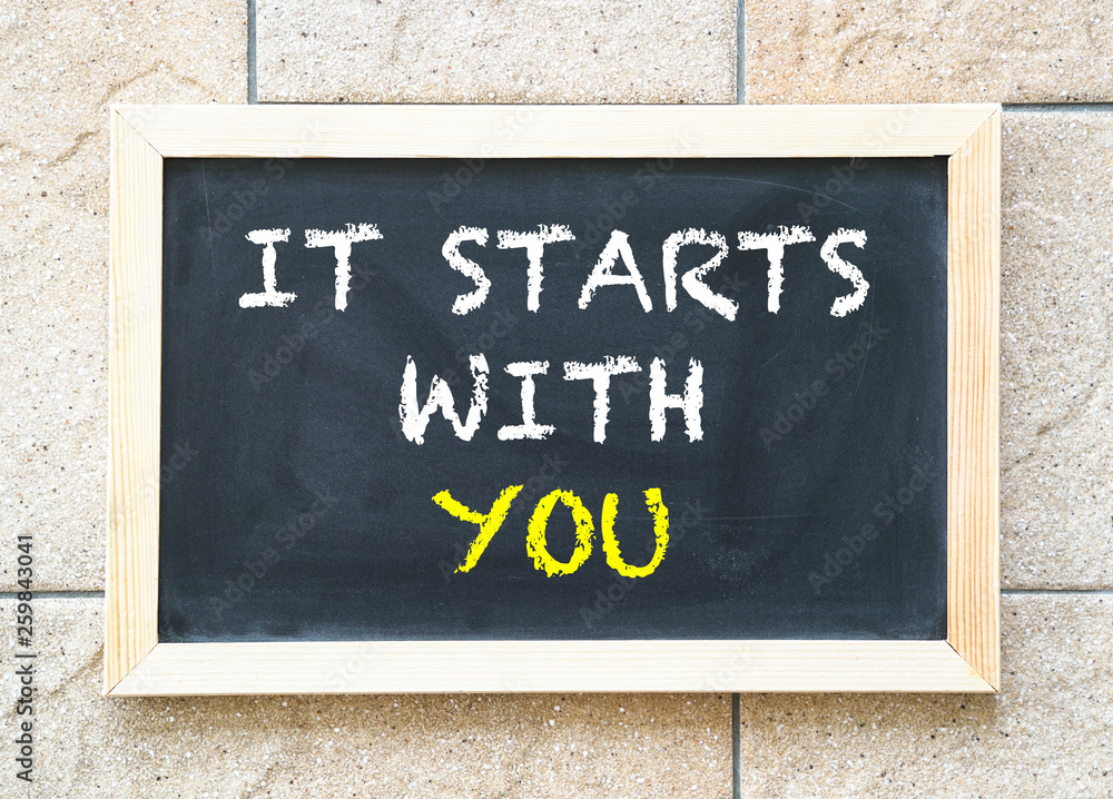It starts with you, words on blackboard