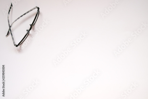 Copy space : White background with reading glasses on the side photo