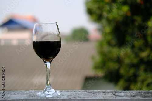 glass of red wine in hand