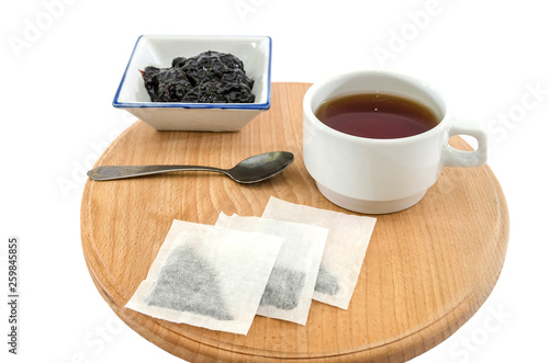 tea and jam on a wooden board and on a white background