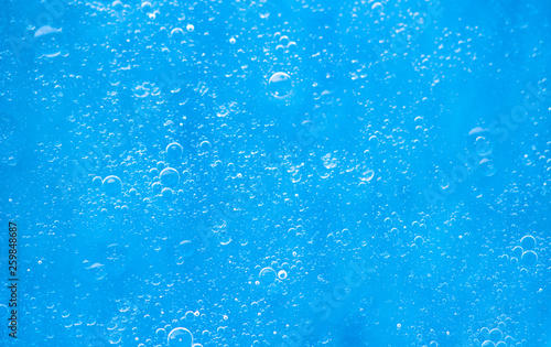 Air bubbles in the water background.Abstract oxygen bubbles in the sea.Circle foamy air in the ocean.Water bubbles isolate on blue background