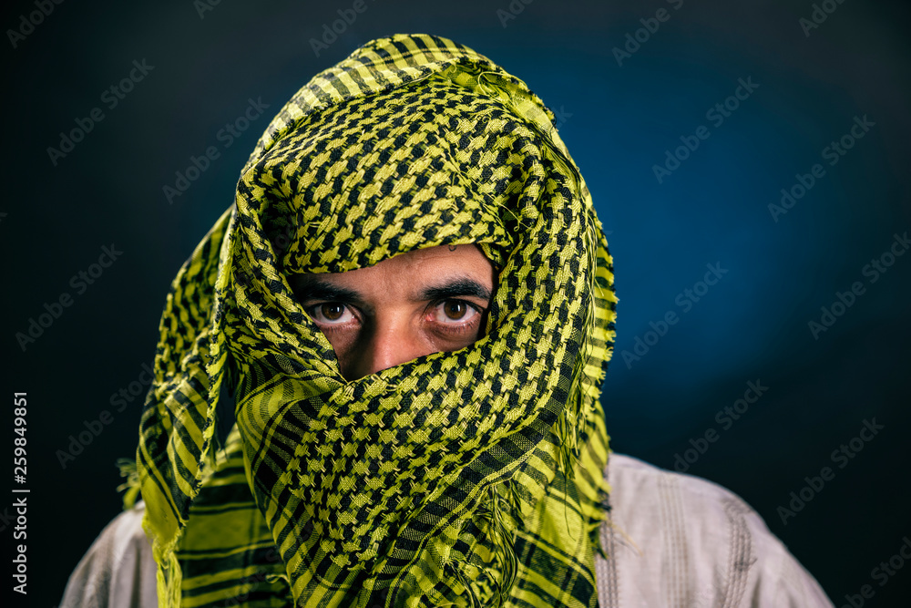 Eastern appearance a man in a traditional national Arab dress covered his  face with a handkerchief, leaving only his eyes. Stock-foto | Adobe Stock