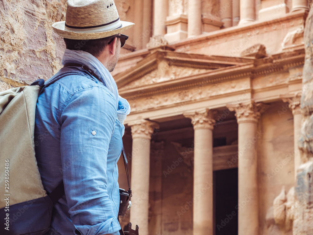Fashionable tourist, exploring the sights of the ancient, fabulous city of Petra in Jordan. Colorful photos. Concept of leisure, vacation and travel
