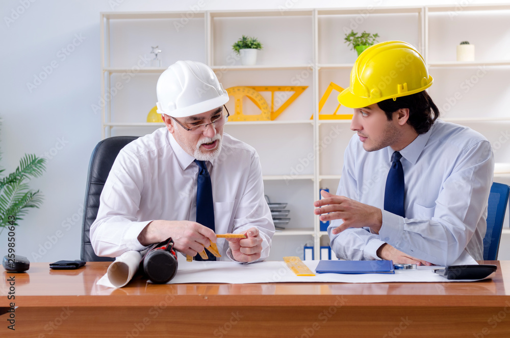 Two engineers colleagues working under project Two engineers colleagues working under project