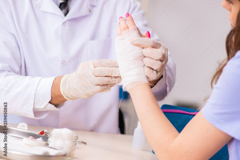 Hand injured woman visiting doctor traumatologist Hand injured woman visiting doctor traumatologist