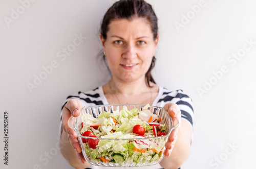 Woman hands holding vegan vegetable salad
