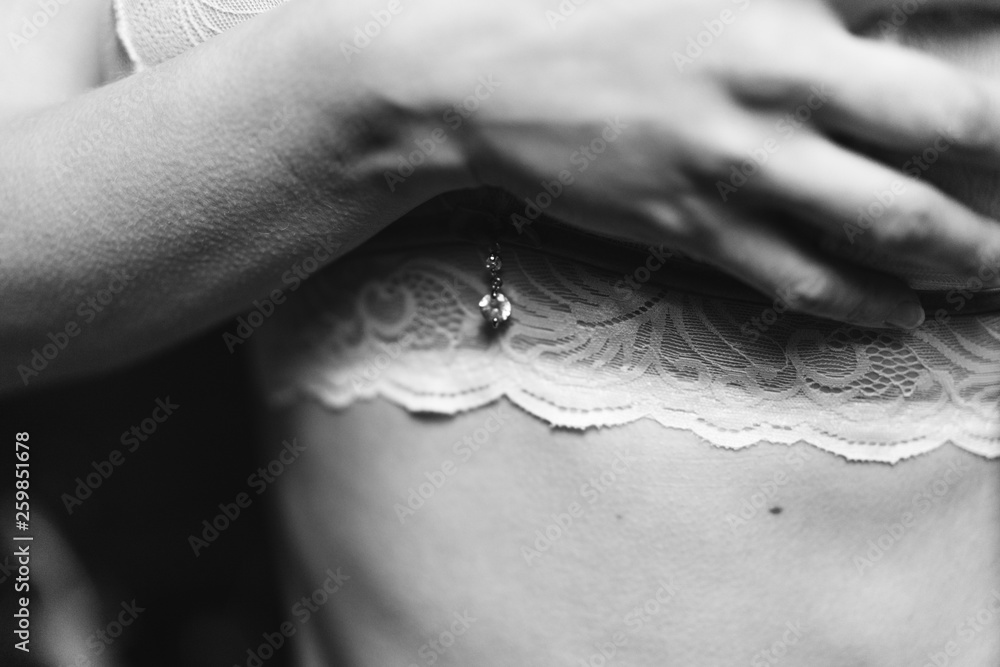  woman covers her chest in her bra with her hand, black and white photo, selective focus