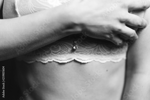  woman covers her chest in her bra with her hand, black and white photo, selective focus © Людмила Таможенко