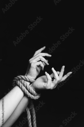 tied hands on black background