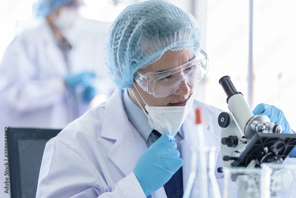 Asian scientist team has researching in laboratory. Asian scientist team has researching in laboratory.