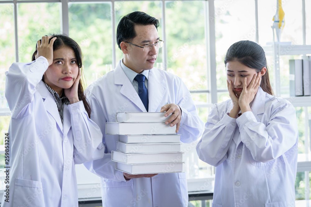 Senior asian scientist has assigning new job to students in laboratory. Senior asian scientist has assigning new job to students in laboratory.
