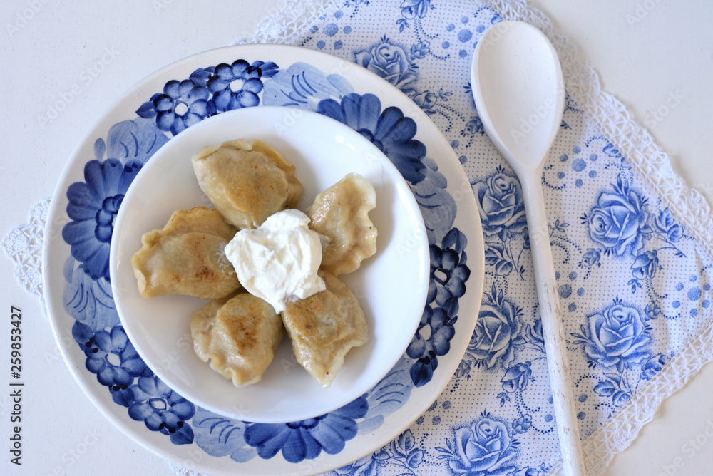 Dumplings pierogi with sour cream
