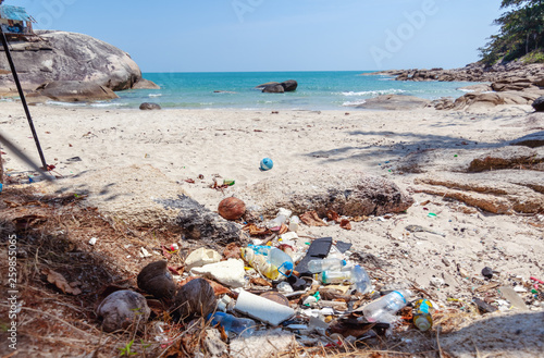 a lot of trash on a beautiful tropical beach. Waste problems, nature pollution with plastic. Ecology and Earth Day