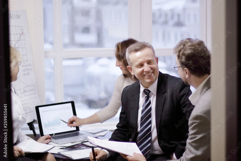 business partners engaged in dialogue in a modern office. business partners engaged in dialogue in a modern office.