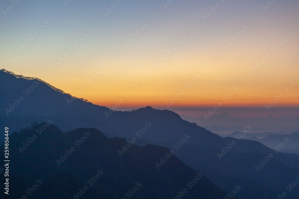 Majestic sunset in the mountains landscape with sunny beams. Dramatic scene. Sri Lanka Ella