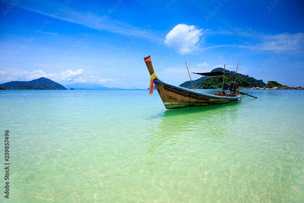 Boat in beautiful sea beach with bright blue sky at Ranong ,Thailand Boat in beautiful sea beach with bright blue sky at Ranong ,Thailand