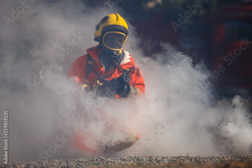 Firefighter with fire fighting equipment and accessories on white background