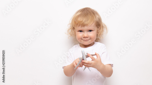 banner child playing with toy airplane against on a white background. concept dreams of flight