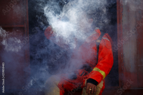 Firefighter with fire fighting equipment and accessories