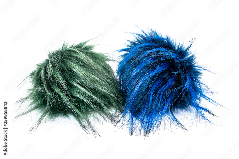 Two fur ball isolated on white background. Green and blue fur ball isolated Two fur ball isolated on white background. Green and blue fur ball isolated