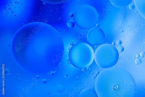 water drops on glass with blue background, close-up 