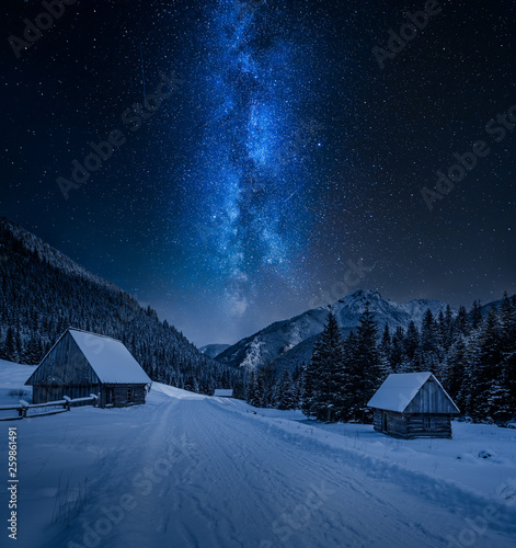 Fototapeta Naklejka Na Ścianę i Meble -  Milky way over small cottages in winter Tatra mountains, Poland