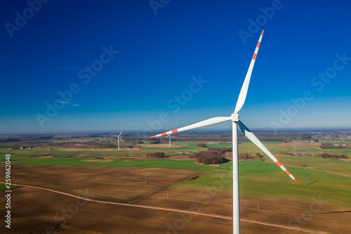 Aerial view of white wind turbines in a field