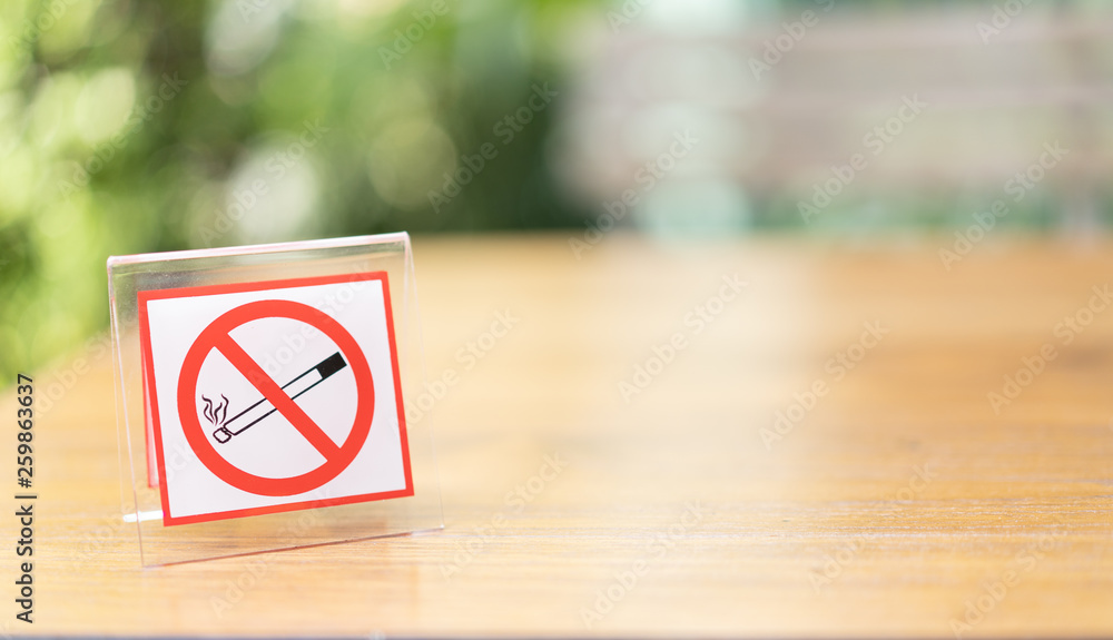 No smoking sign position on the left of the wood table No smoking sign position on the left of the wood table