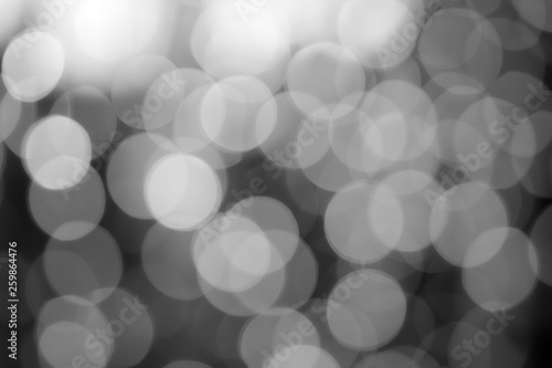 abstract defocused black and white bokeh or bubble from light party on stage at dark night for background and christmas festival