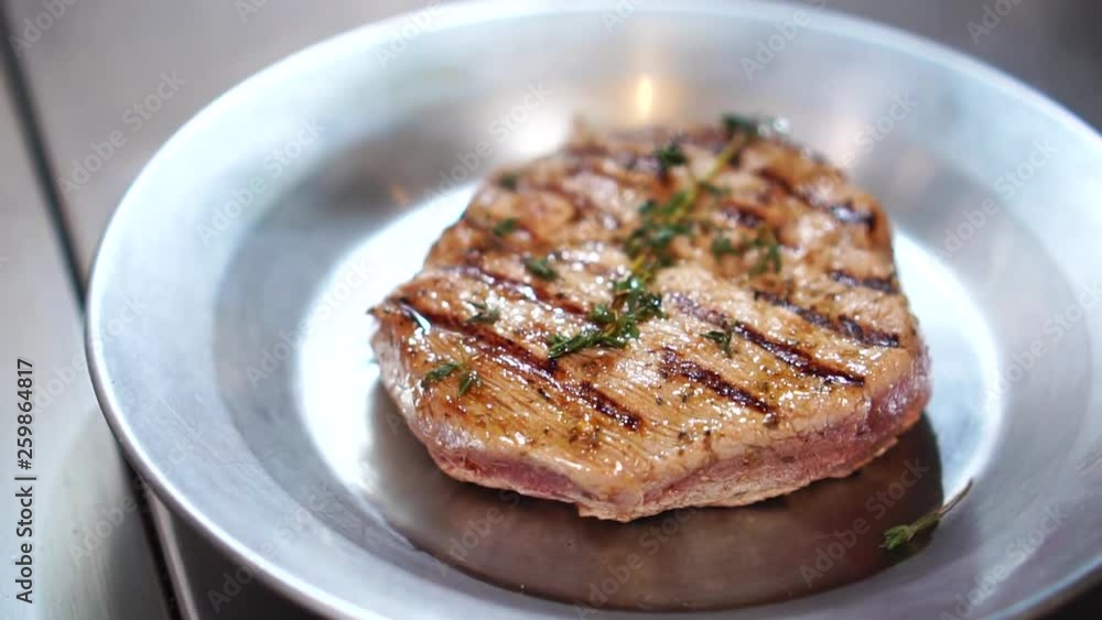 Delicious fried pork ribs beef meat slices in hot steamy grill pan in detailed close up slow motion Delicious fried pork ribs beef meat slices in hot steamy grill pan in detailed close up slow motion