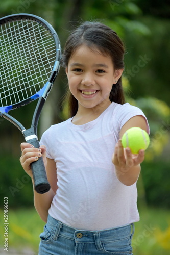 Minority Child Athlete And Happiness With Tennis Racket © dtiberio