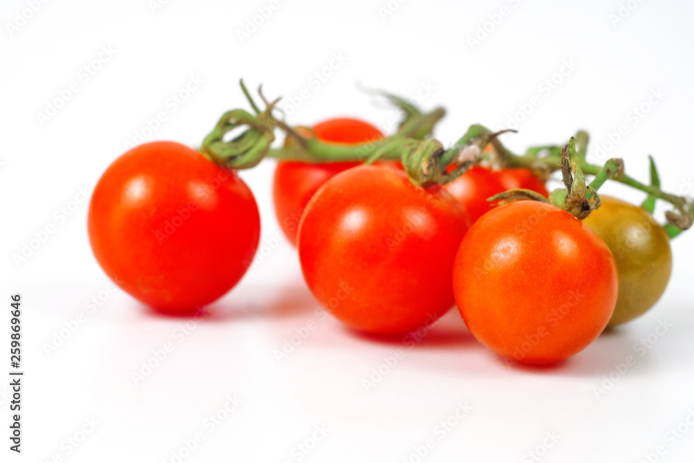 Small Tomato on white background.Food concept. Small Tomato on white background.Food concept.