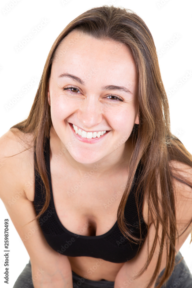 Smiling young fitness woman sitting on the floor Smiling young fitness woman sitting on the floor